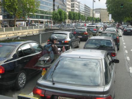 Figure 2. Photo of a scooter rider filtering through urban traffic.